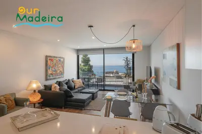 a living room with a couch and a table at OurMadeira - Bayside in Câmara de Lobos
