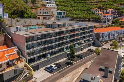 an aerial view of a building in a city at OurMadeira - Bayside in Câmara de Lobos