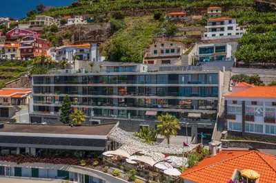 an aerial view of a city with buildings at OurMadeira - Bayside in Câmara de Lobos