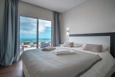a white bedroom with a large bed with towels on it at Villa Azinhaga in Gaula