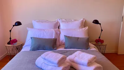 a bed with two towels on top of it at Casa ideal para famílias com vista mar desafogada in Funchal