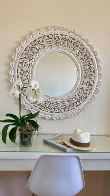 a mirror on a shelf with a hat and a chair at Casa ideal para famílias com vista mar desafogada in Funchal