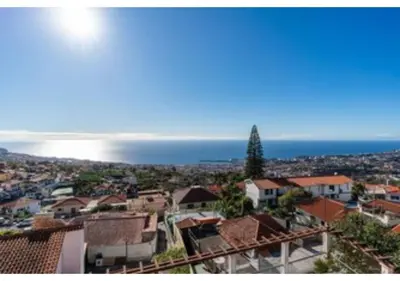a balcony with a table and chairs and a view at Casa Monte in Funchal