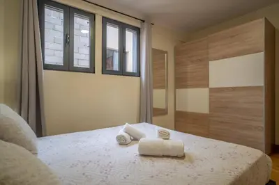 a kitchen with a table with chairs and a washer at Vista Vieira Apartments in Funchal