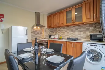 a living room with a couch and a kitchen at Vista Vieira Apartments in Funchal