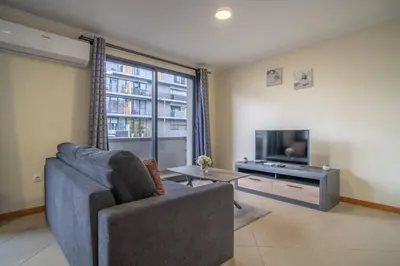a living room with a couch and a flat screen tv at Vista Vieira Apartments in Funchal