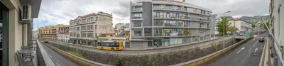a living room with a couch and a tv at Vista Vieira Apartments in Funchal
