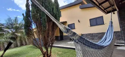a blue hammock in front of a house at MORADIA - VIEIRA in Machico
