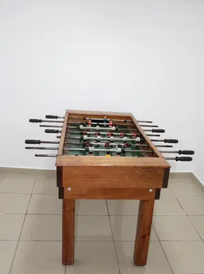 a foosball table in front of a group of cuesticks at MORADIA - VIEIRA in Machico