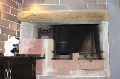 a brick oven with a black pot in it at MORADIA - VIEIRA in Machico