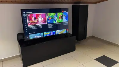 a flat screen tv sitting on top of a black stand at MORADIA - VIEIRA in Machico
