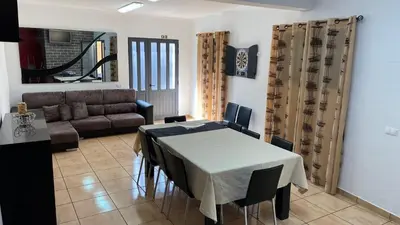 a living room with a table and a couch at MORADIA - VIEIRA in Machico