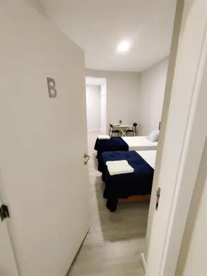 a room with two beds and a hallway at Funchal Apartments - New Botanic Garden Petit Studios in Funchal