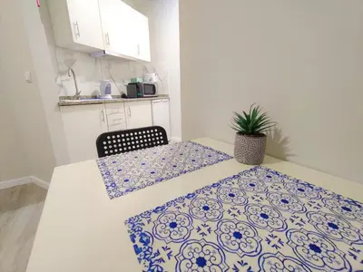 a small kitchen with a table and a chair at Funchal Apartments - New Botanic Garden Petit Studios in Funchal