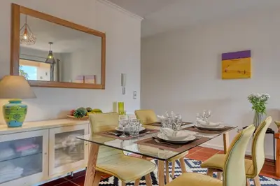 a dining room with a glass table and chairs at Porto Santo Pip House, a Home in Madeira in Porto Santo