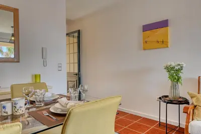 a dining room with a table and chairs at Porto Santo Pip House, a Home in Madeira in Porto Santo