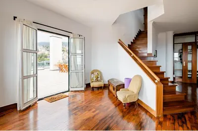 an open living room with a staircase and a stair case at A ver o mar rooms- Funchal city center in Funchal
