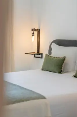 a bedroom with a white bed with green pillows at Uptown 13 apartment by An Island Apart in Funchal