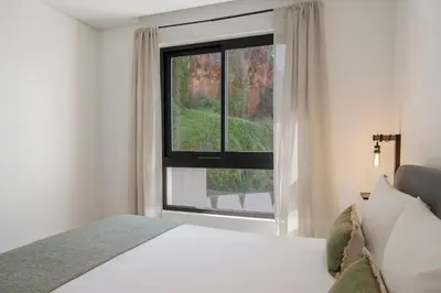 a bedroom with a bed and a large window at Uptown 13 apartment by An Island Apart in Funchal