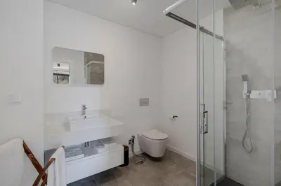 a white bathroom with a sink and a shower at Uptown 13 apartment by An Island Apart in Funchal