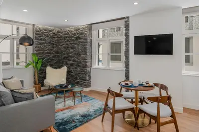 a living room with a couch and a table at Queimada Lodges by An Island Apart in Funchal