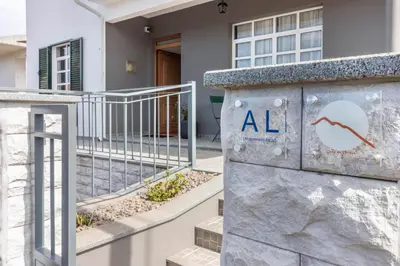a sign in front of a house with an all sign on it at Casa da Olides - T3 and Studio in Santana