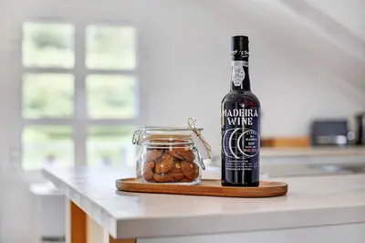 a bottle of beer and a jar of nuts on a counter at Casa da Olides - Studio in Santana