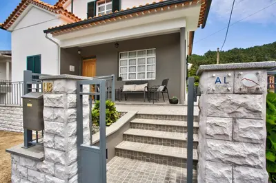 a house with a gate and stairs in front of it at Casa da Olides - Studio in Santana
