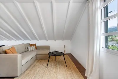 a living room with a couch and a table at Casa da Olides - Studio in Santana