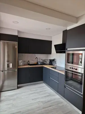 a kitchen with blue cabinets and stainless steel appliances at Ocean Paradise do Til in Funchal