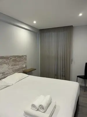 a bedroom with a white bed with towels on it at Ocean Paradise do Til in Funchal