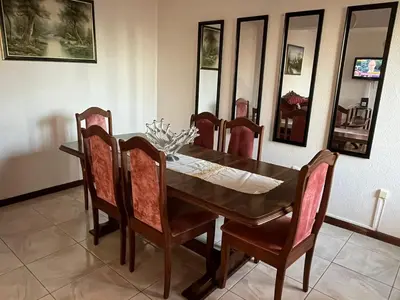 a living room with two chairs and a tv at Casa da Isilda ,three bedrooms in Estreito da Calheta