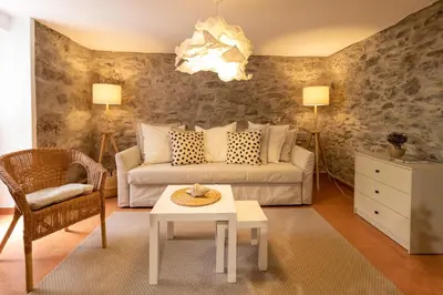 a living room with a couch and a table at Seaside Green House, Paúl do Mar T2 in Paul do Mar