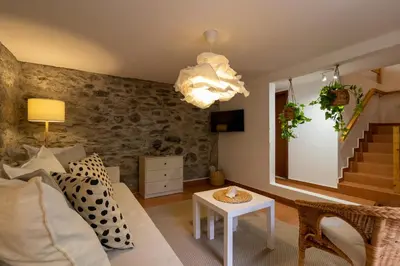 a living room with a couch and a table at Seaside Green House, Paúl do Mar T2 in Paul do Mar