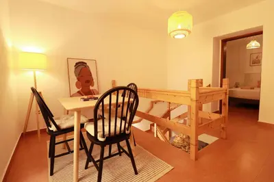 a room with a table and chairs and a dining room at Seaside Green House, Paúl do Mar T2 in Paul do Mar