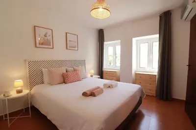 a bedroom with a bed with two towels on it at Seaside Green House, Paúl do Mar T2 in Paul do Mar