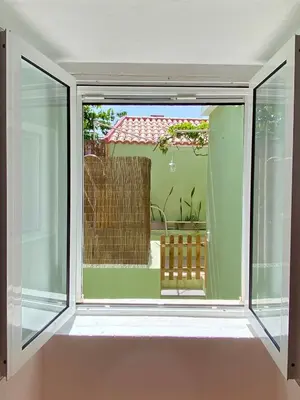 an open window with a view of a patio at Seaside Green House, Paúl do Mar T2 in Paul do Mar