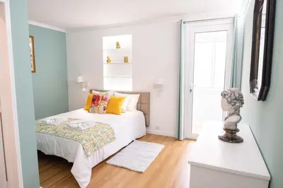 a small bedroom with a bed and a window at D.Henrique I apartamento frente ao Savoy Palace in Funchal