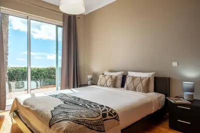 a bedroom with a large bed and a large window at Magnolia Sunsets in Calheta