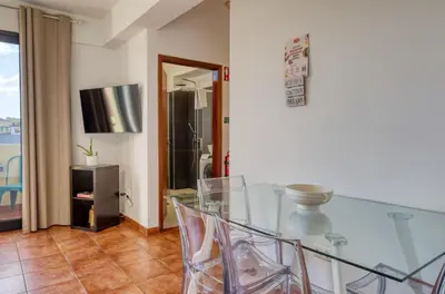 a bedroom with a white bed with two pictures on the wall at Beco Santa Emilia 4N, a Home in Madeira in Funchal