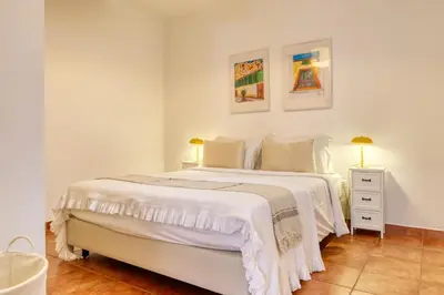 a wooden table and chairs on a balcony at Beco Santa Emilia 4N, a Home in Madeira in Funchal