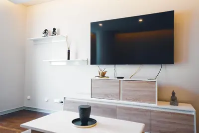 a living room with a flat screen tv on a wall at Funchal Centrum Apartment in Funchal