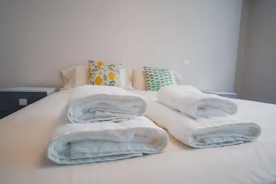 a pile of towels sitting on top of a bed at Funchal Centrum Apartment in Funchal