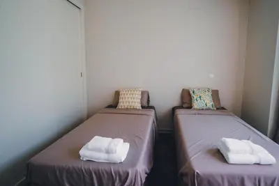 two beds with towels on them in a room at Funchal Centrum Apartment in Funchal