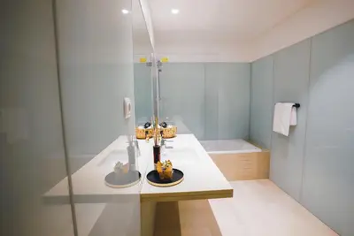 a bathroom with a shower and a sink and a tub at Funchal Centrum Apartment in Funchal
