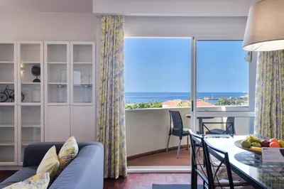 a living room with a couch and a table with a view at GuestReady - Serenity by the Sea near Funchal Bay in Funchal