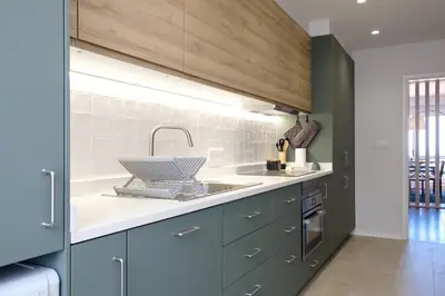 a kitchen with blue cabinets and a sink at GuestReady - Serenity by the Sea near Funchal Bay in Funchal