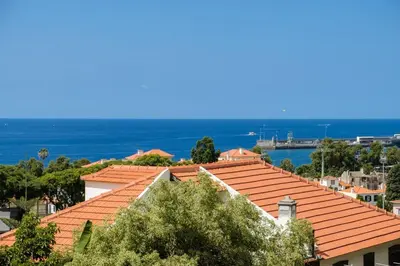 a view of roofs of houses and the ocean at GuestReady - Serenity by the Sea near Funchal Bay in Funchal