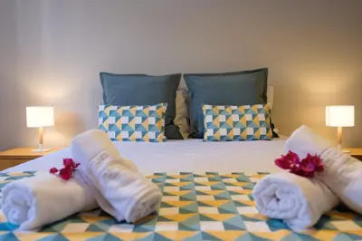 a bedroom with a bed with white socks and towels at GuestReady - Serenity by the Sea near Funchal Bay in Funchal