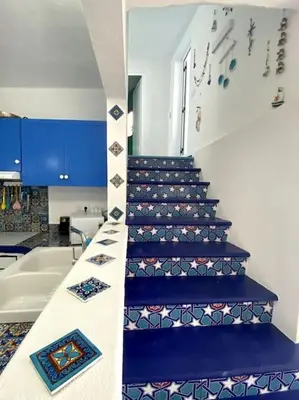 a stairway with blue steps in a room at Casa Santorini in Ribeira Brava